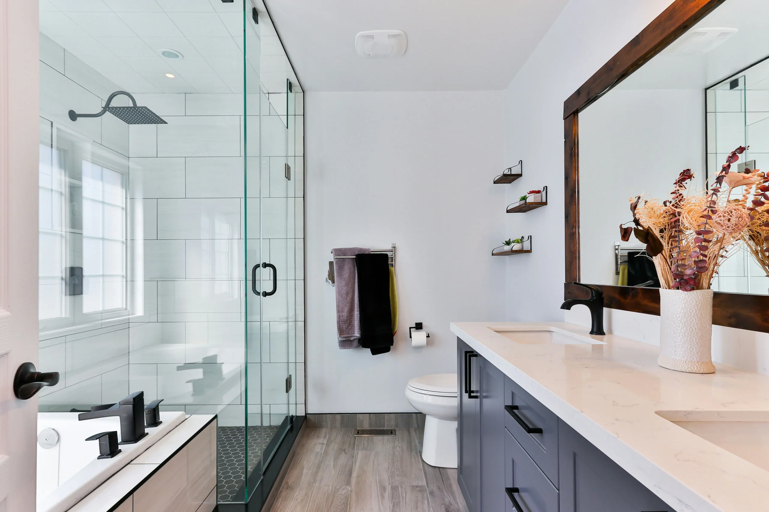 A recently cleaned residential bathroom with glass walk-in shower.